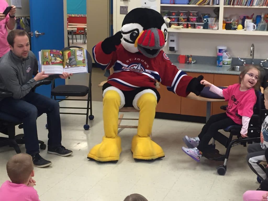 Kory Harnum reads a book during a community relations event.