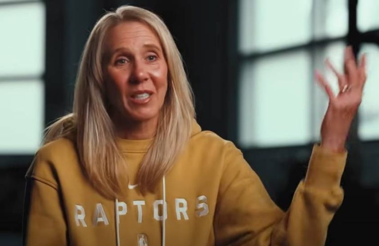 Carmen Dick speaking and gesturing while wearing a Toronto Raptors sweatshirt.