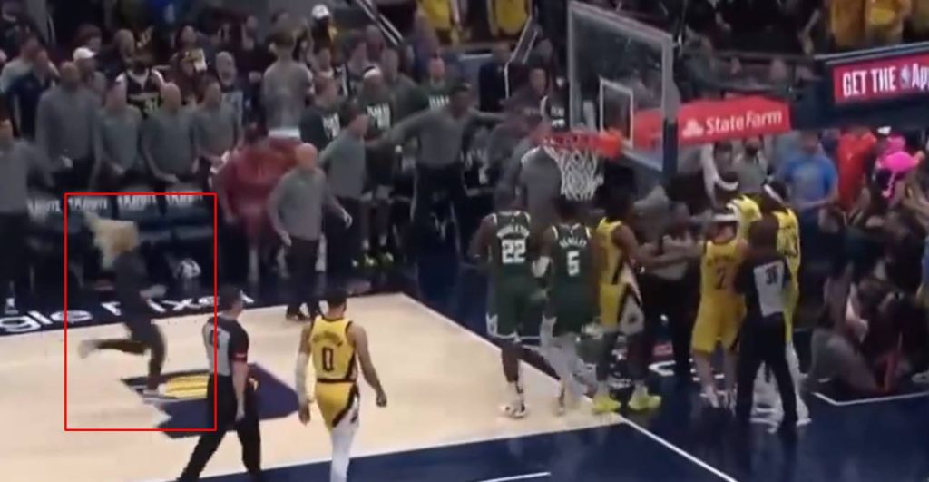Woman running from Pacers bench