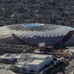 Aerial view of the Intuit Dome, the Los Angeles Clippers’ arena, surrounded by buildings and residential neighborhoods.