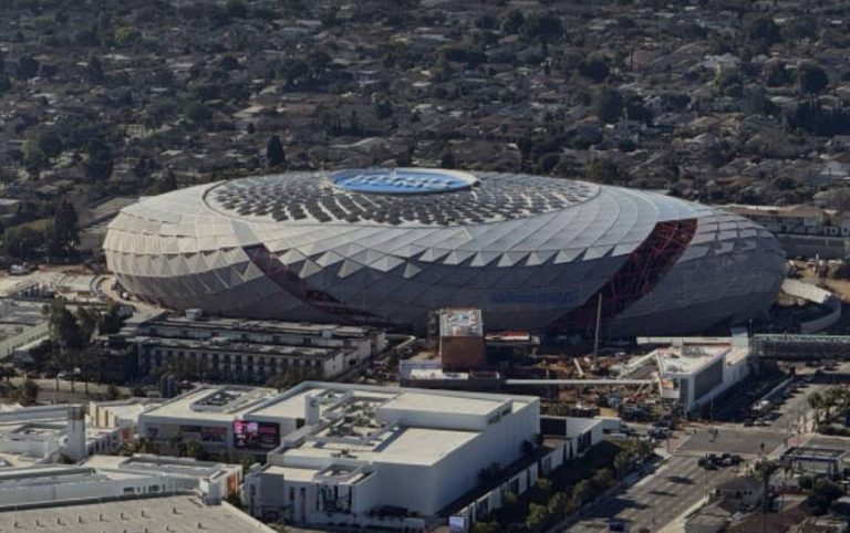 Aerial view of the Intuit Dome, the Los Angeles Clippers’ arena, surrounded by buildings and residential neighborhoods.