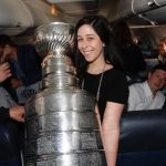 Andi Perelman poses with the Stanley Cup inside a team vehicle.