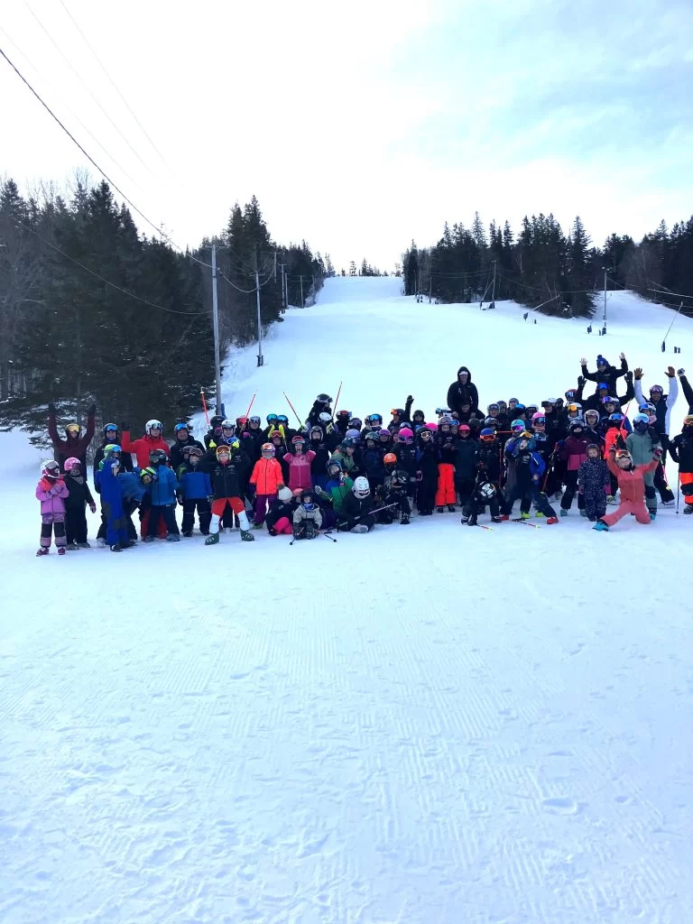 Young Ski NB athletes gather on the snow.