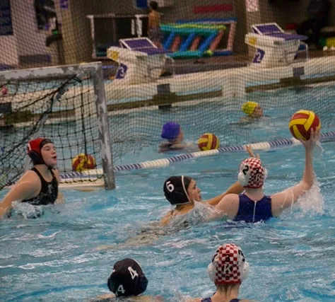 Water polo athletes training in a pool