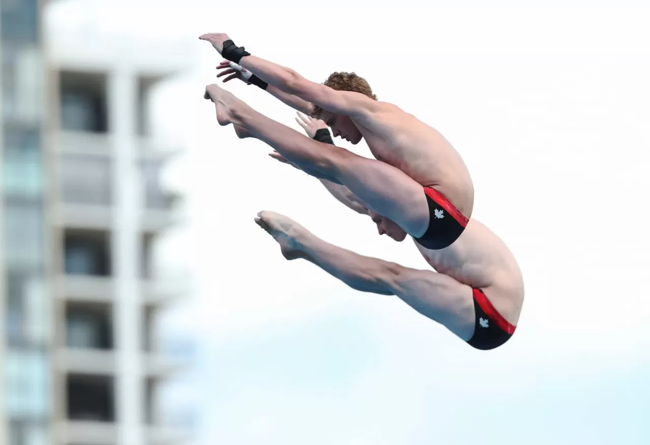 Synchronized diving performance featured by Dive Sask.