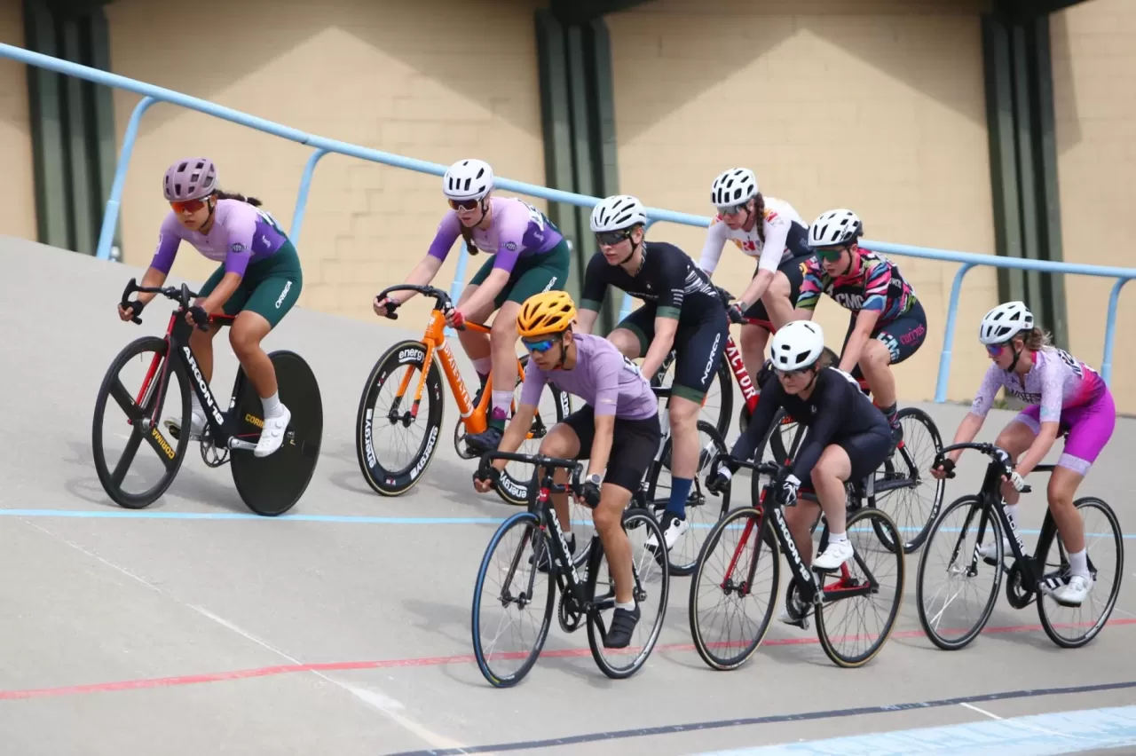 Track cyclists at an indoor velodrome
