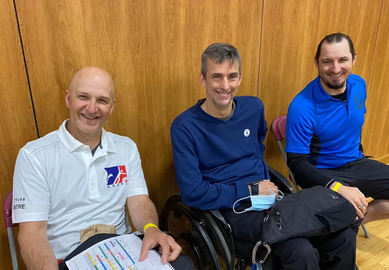 A head referee and coaches featured on AQSPC’s boccia careers page.