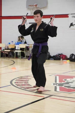 Martial arts weapons form performance featured by the provincial association.