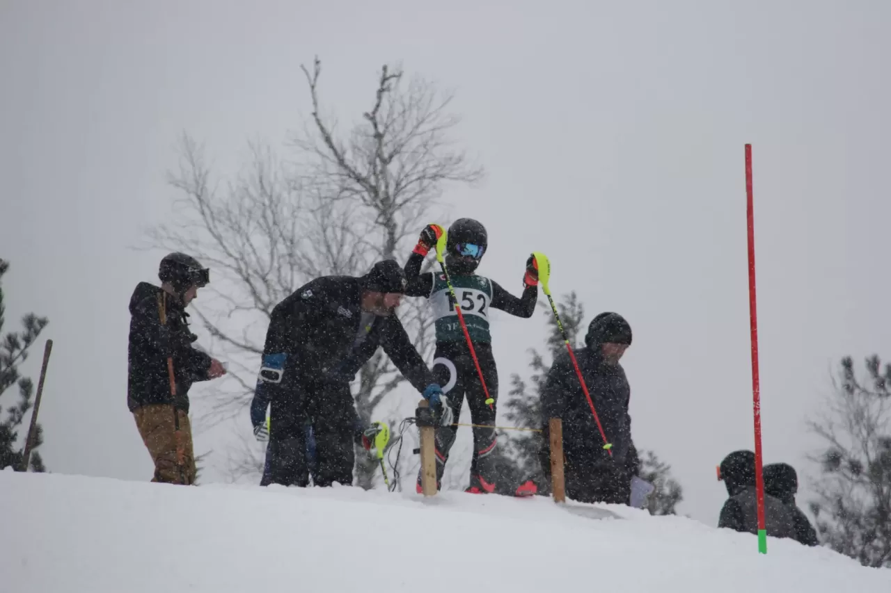 Ski race officials work on the course.