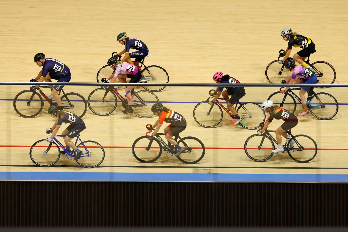 Riders on an indoor cycling track