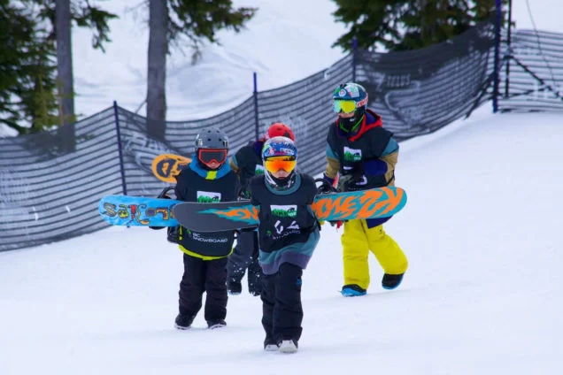 Young BC snowboarders with their boards